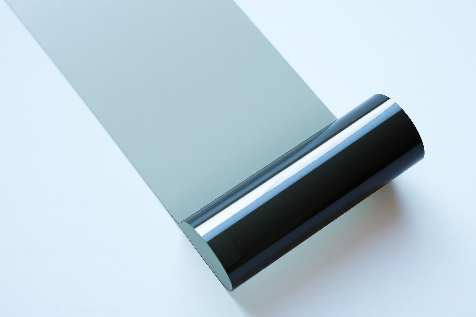 Roll of dark ceramic window film partially unspooled